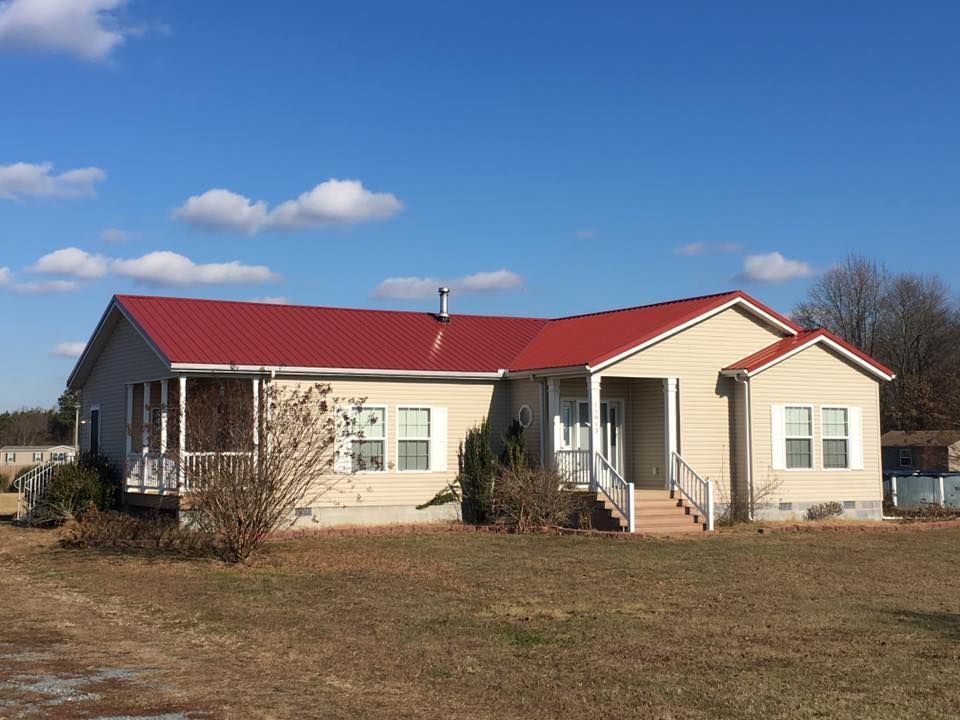 A house with a red roof and white shutters