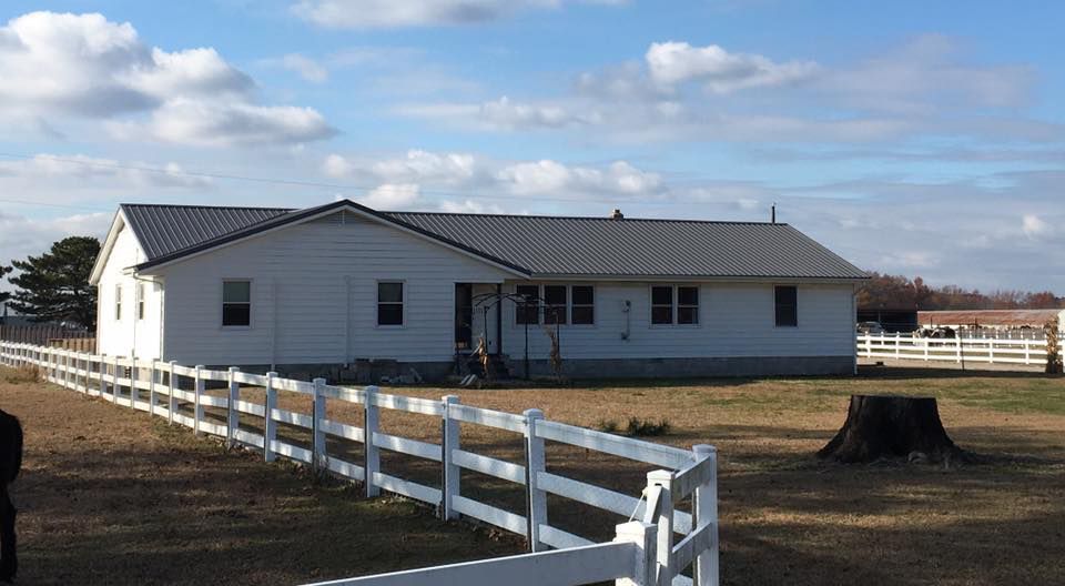 A white house with a white fence around it