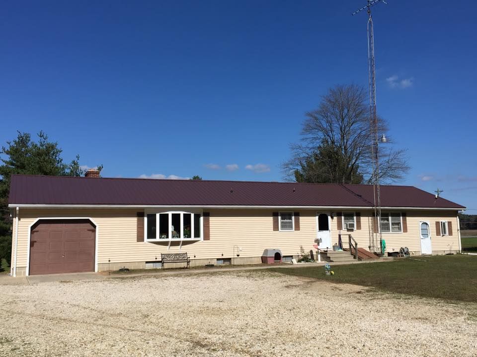 A house with a purple roof and a garage