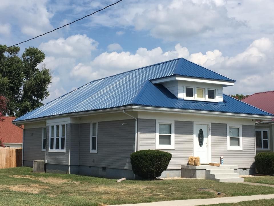 A house with a blue roof and white trim