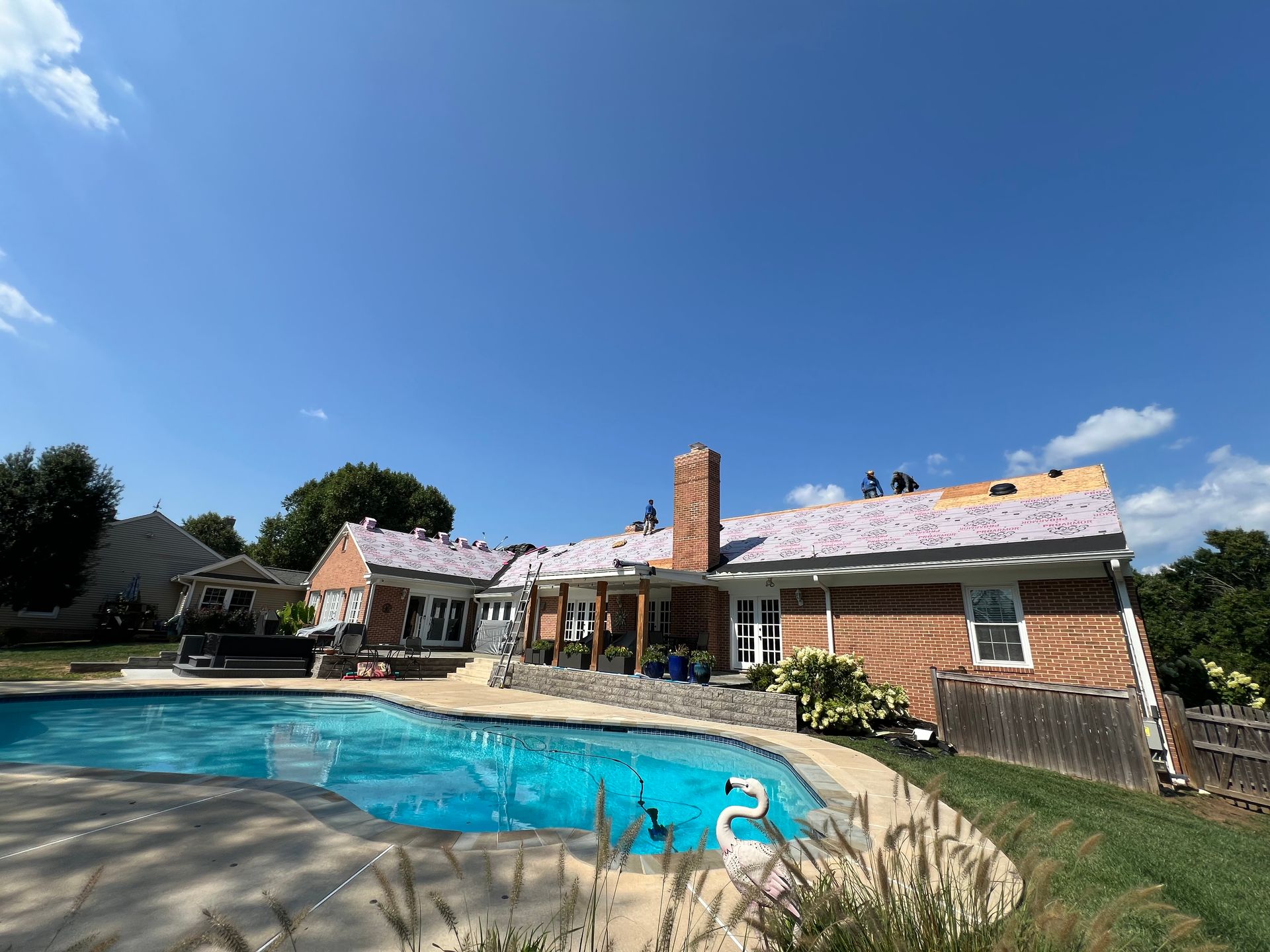 A large house with a swimming pool in front of it.