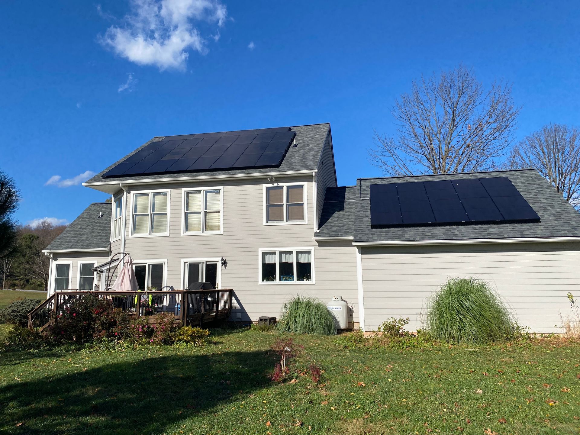 The back of a house with solar panels on the roof.