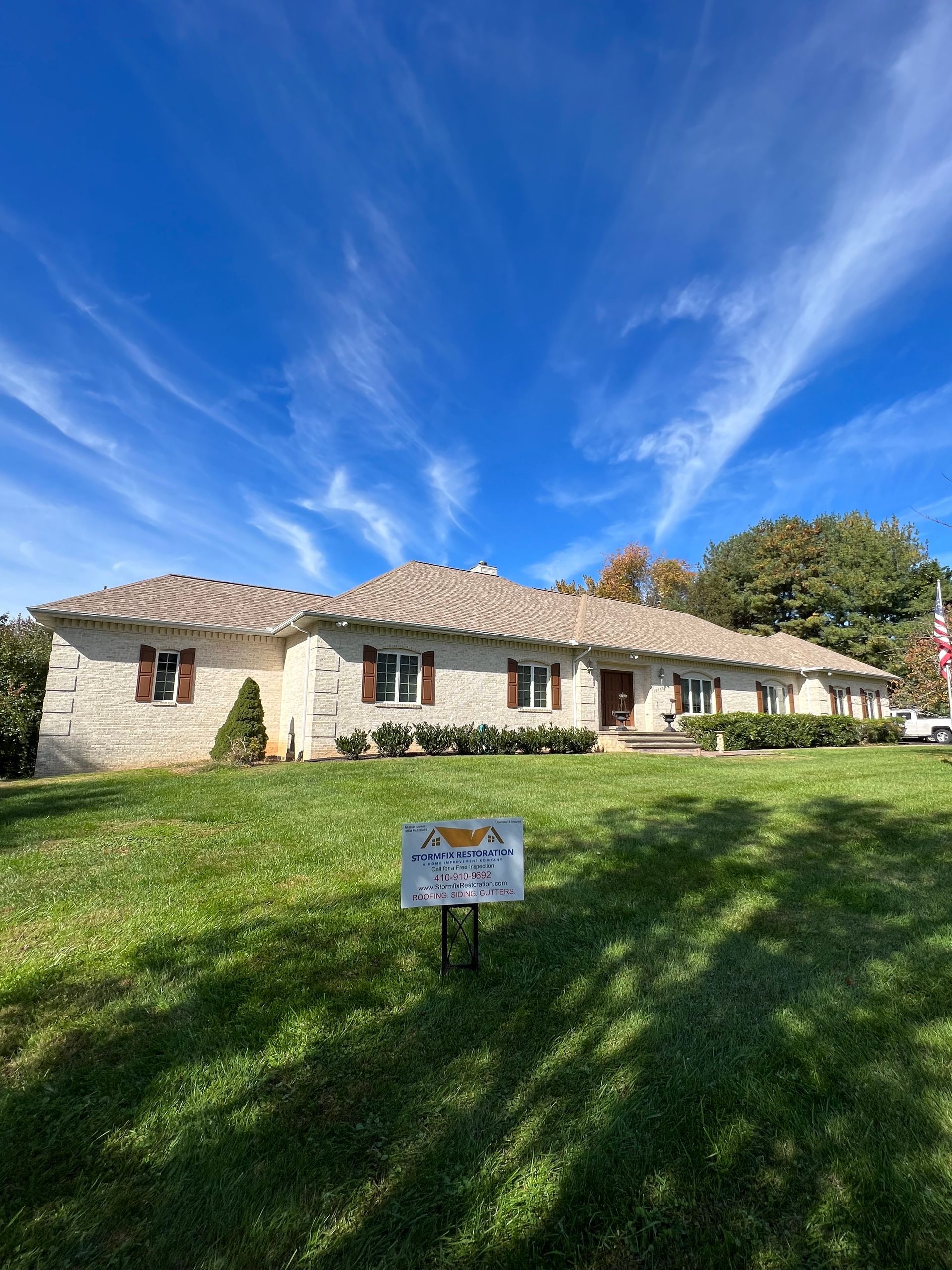 A large house with a sign in front of it.