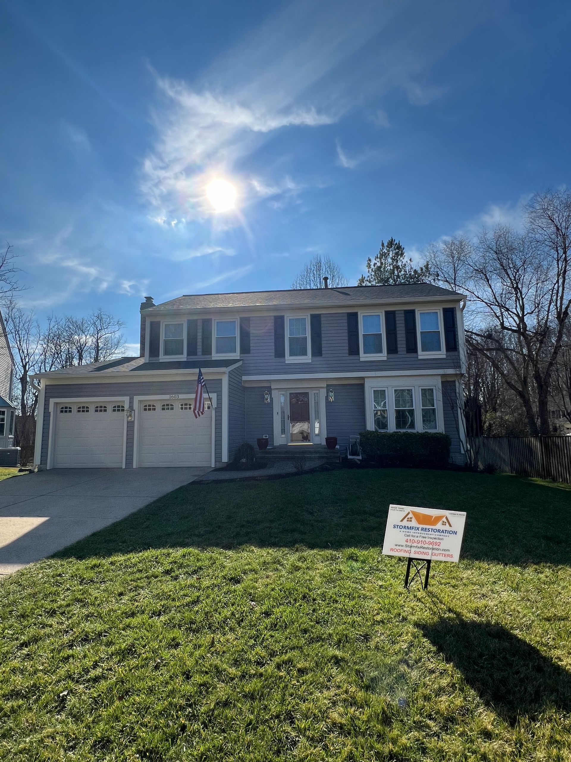 A house with a for sale sign in front of it.