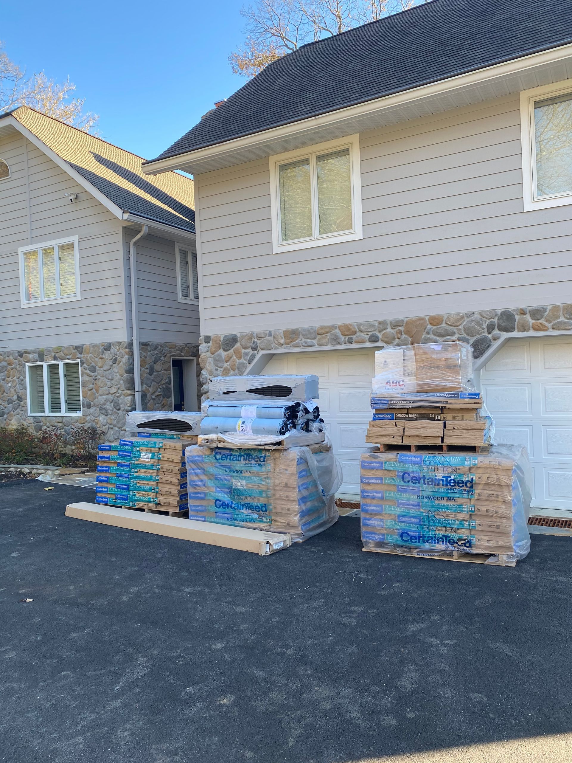 A house with a lot of boxes and pallets in front of it.