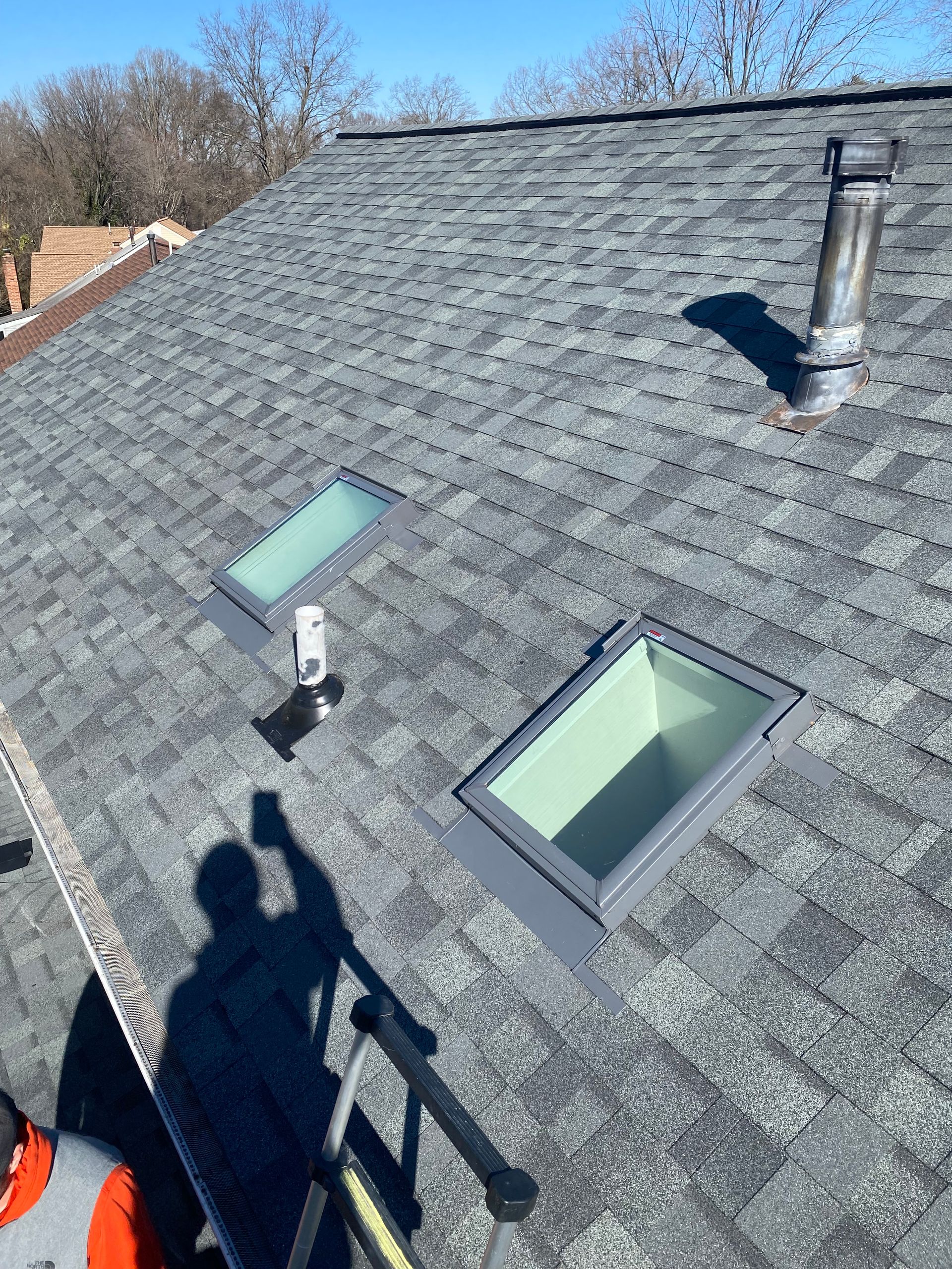 There are two skylights on the roof of a house.
