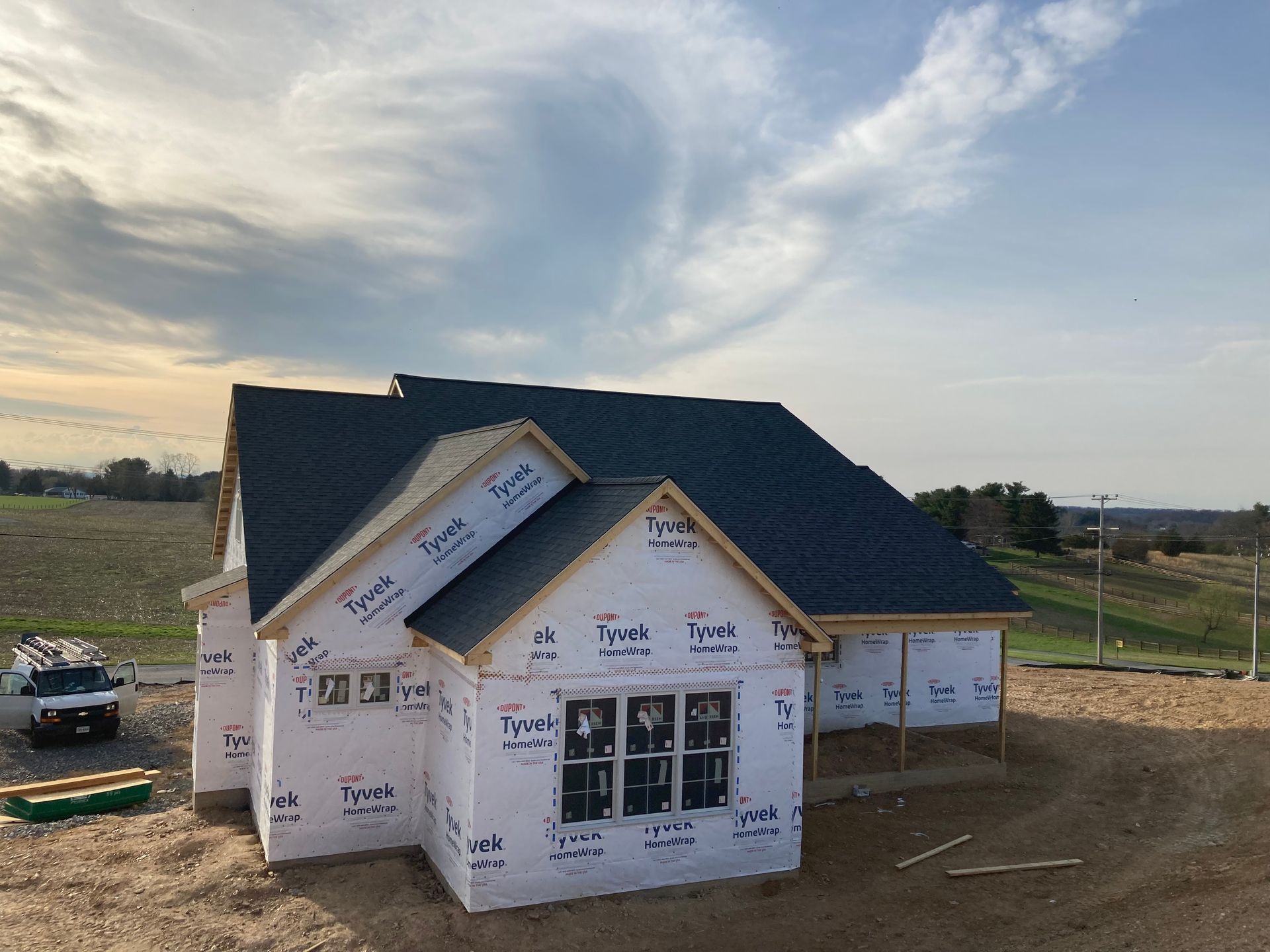 A house that is being built with a blue roof