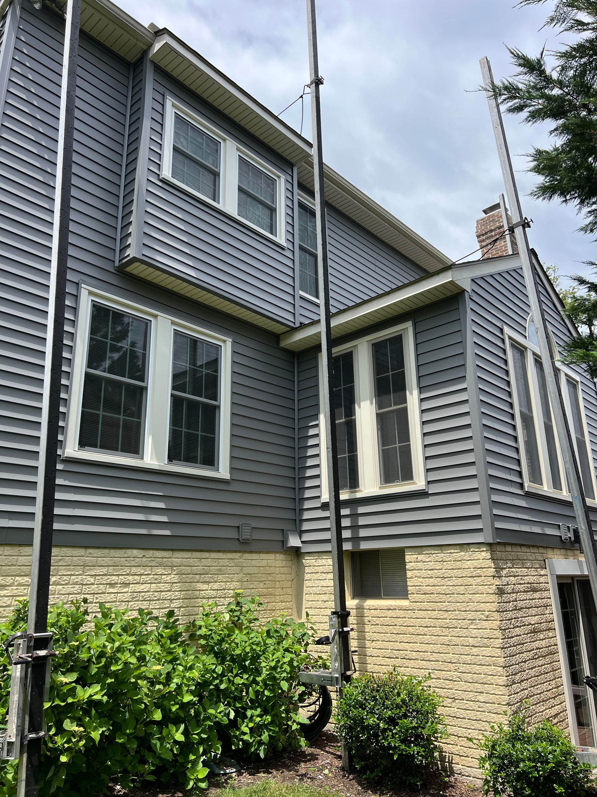 A large house with a lot of windows and a chimney.