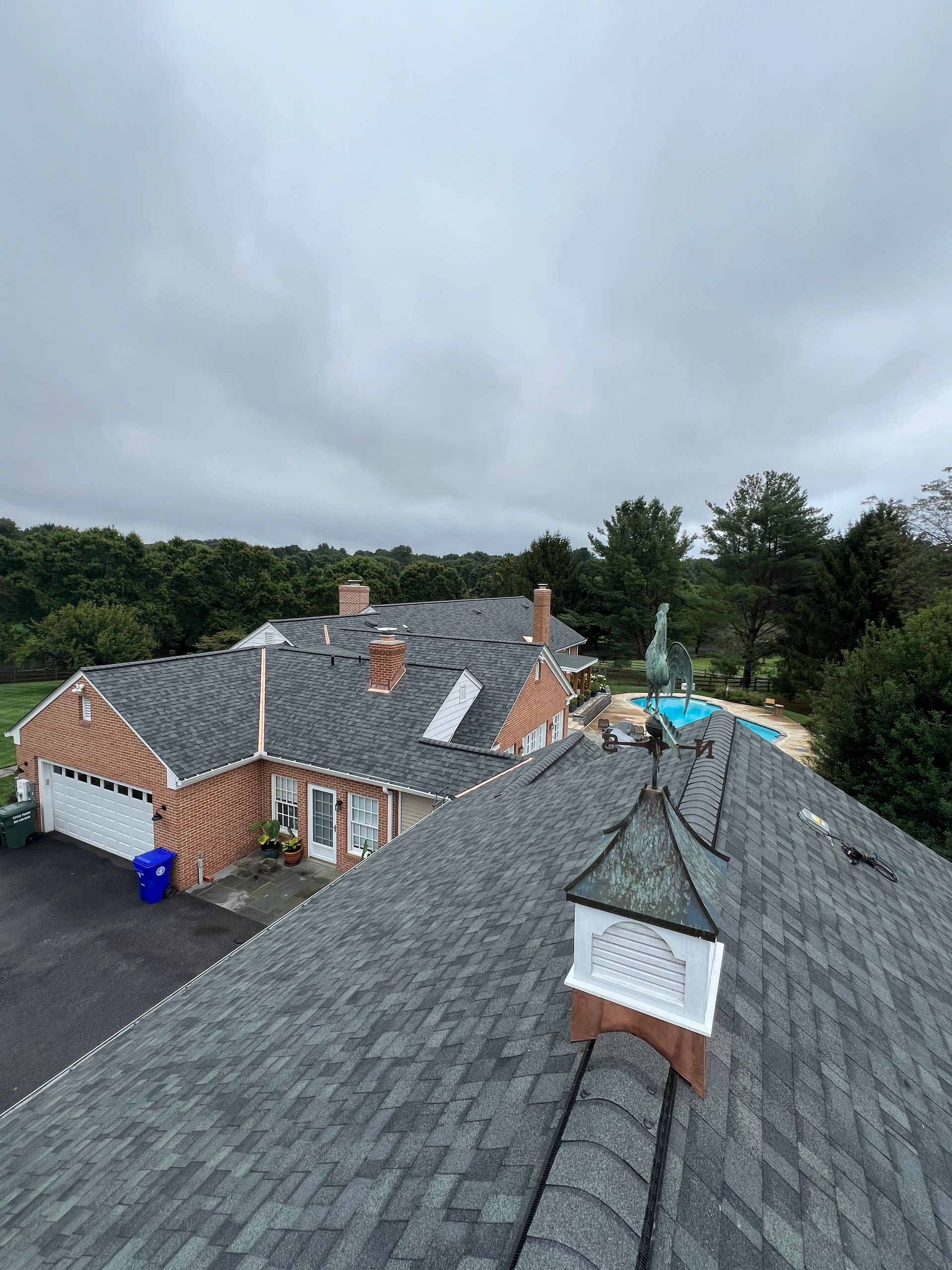 An aerial view of a large house with a gray roof.