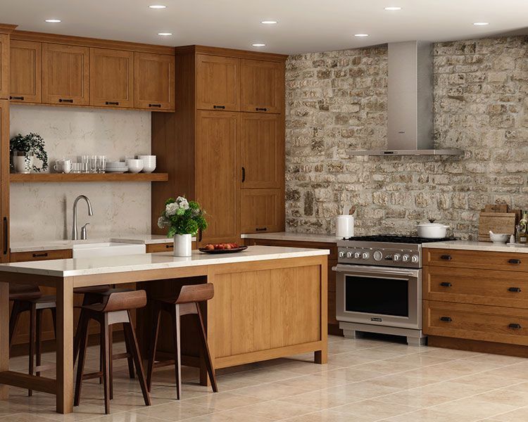 Kitchen with wood cabinets, stone wall, island, and stainless steel appliances.