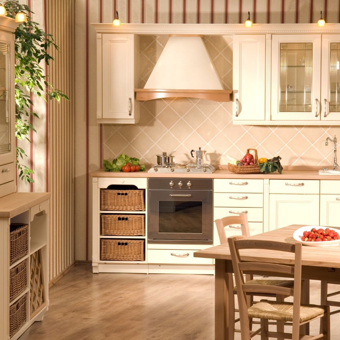 Cozy kitchen with light cabinets, wooden accents, and a dining table.