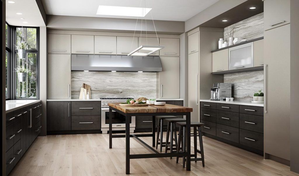 Modern kitchen with dark cabinetry, wooden island, light wood floor, and large window.