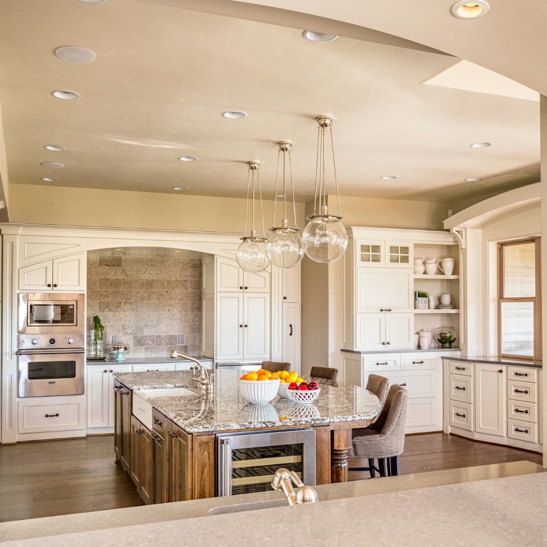 Spacious kitchen with a large island, stainless steel appliances, and white cabinetry.