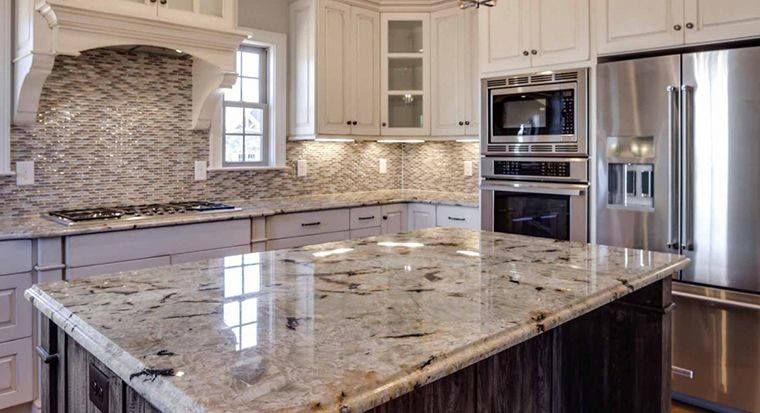 Kitchen with white cabinets, granite countertops, and stainless steel appliances.