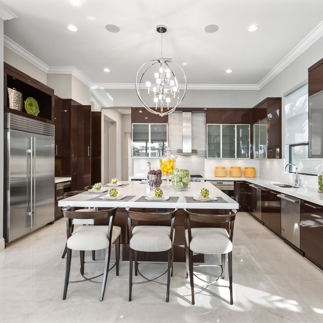 Modern kitchen with a large island, stainless steel appliances, and dark wood cabinets.