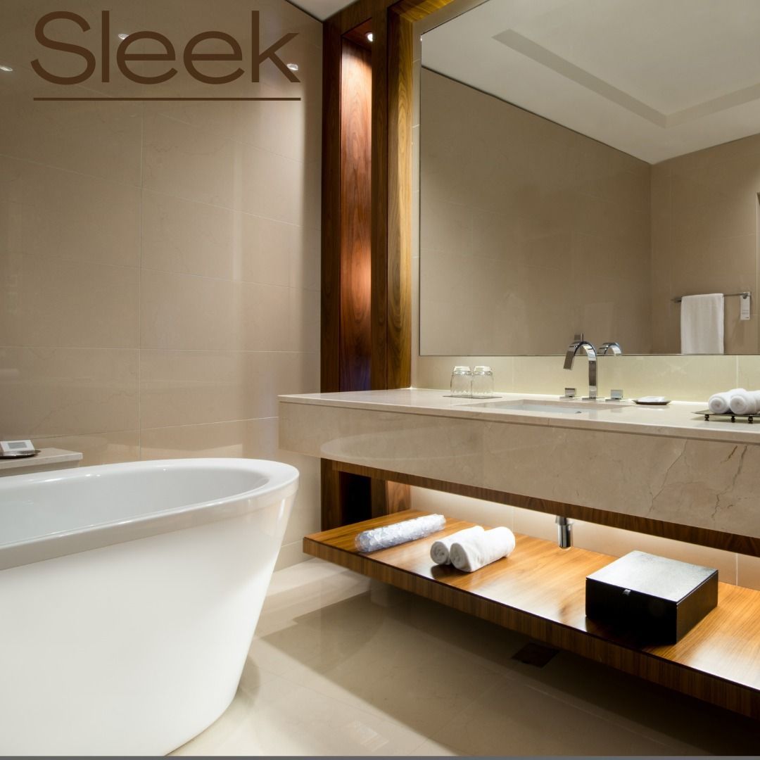 Modern bathroom with a white tub, wooden accents, and a large mirror.