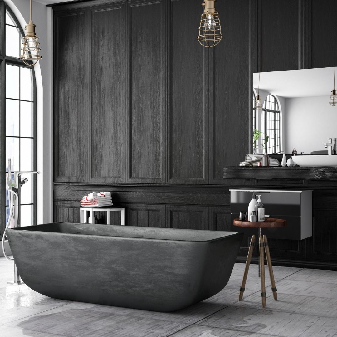 Dark gray bathroom with a freestanding bathtub, black paneling, and a small wooden table.