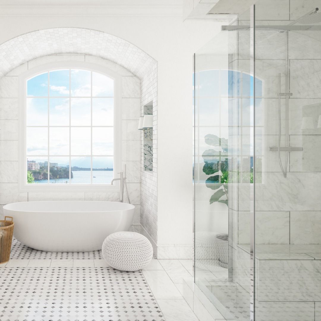 Bright white bathroom with a tub, a large arched window, and a glass shower.