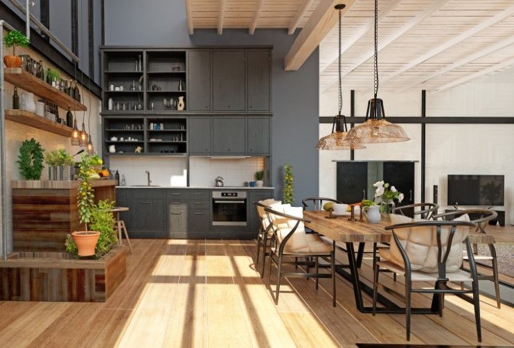 Modern kitchen and dining area with wooden floor, cabinets, and dining table; plants.