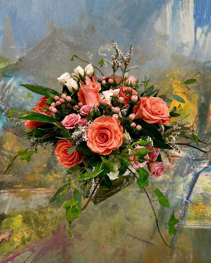 Pink rose bouquet with white and green flowers on a soft abstract background