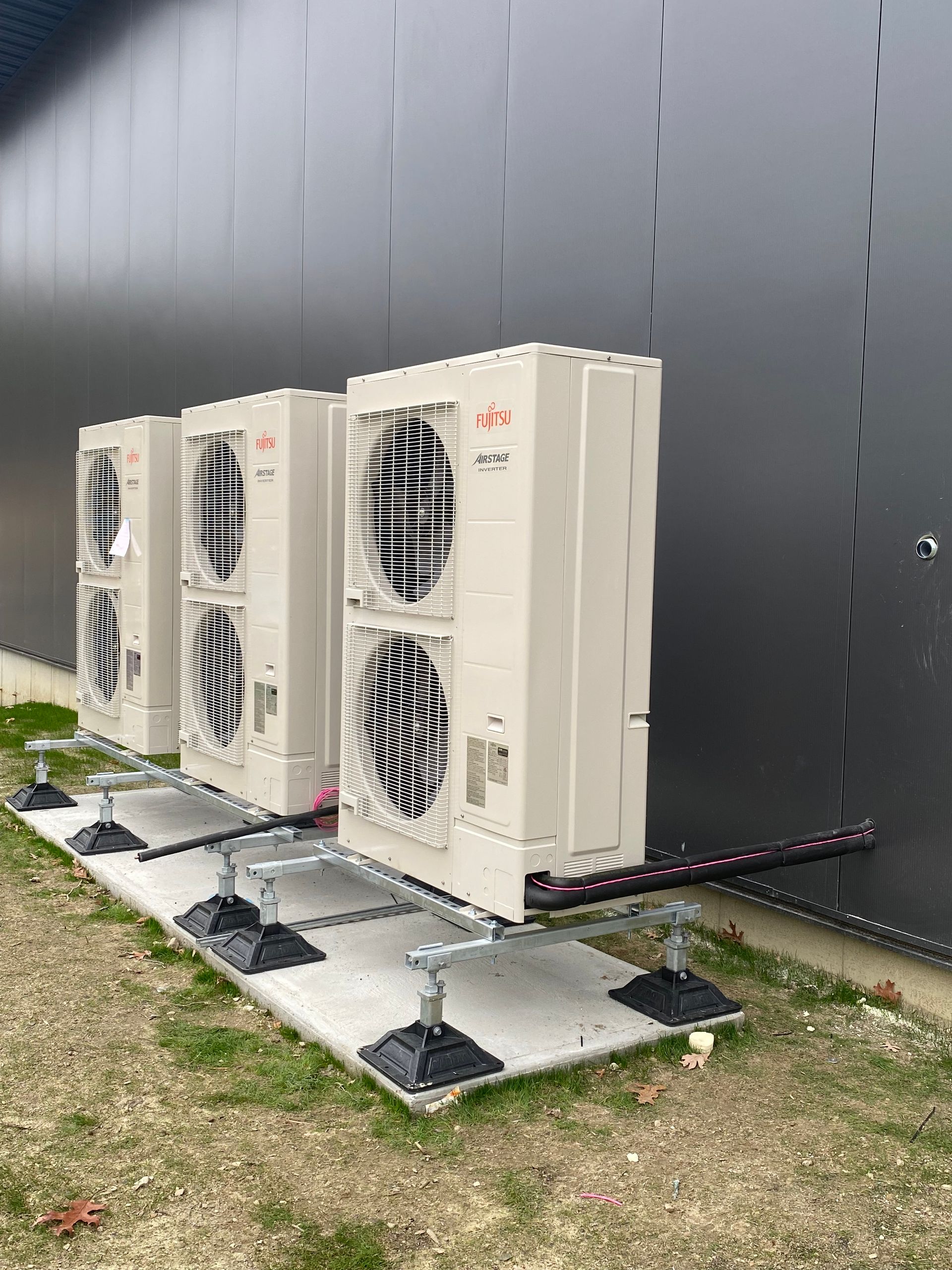 a row of air conditioners are sitting in front of a building