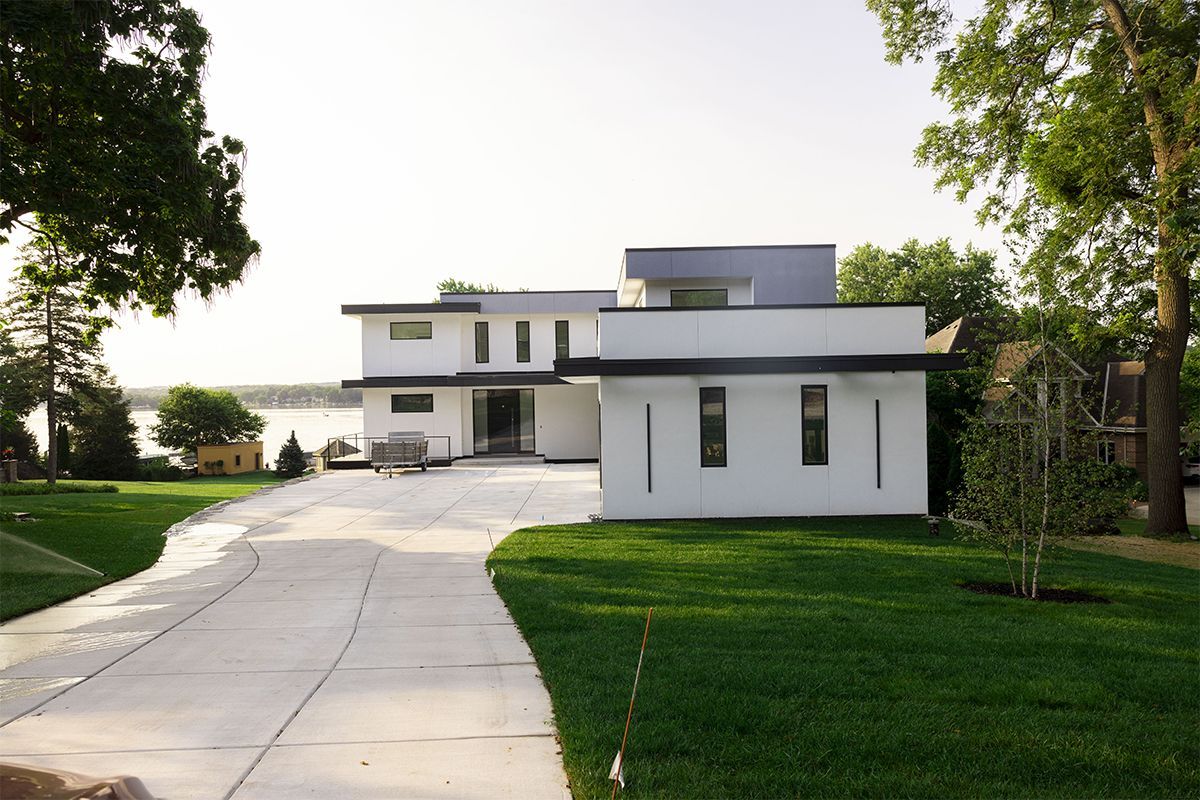 A white house with a driveway leading to it