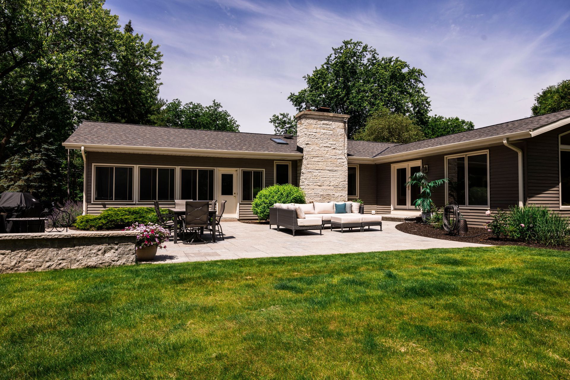 The backyard of a house with a patio and a fireplace