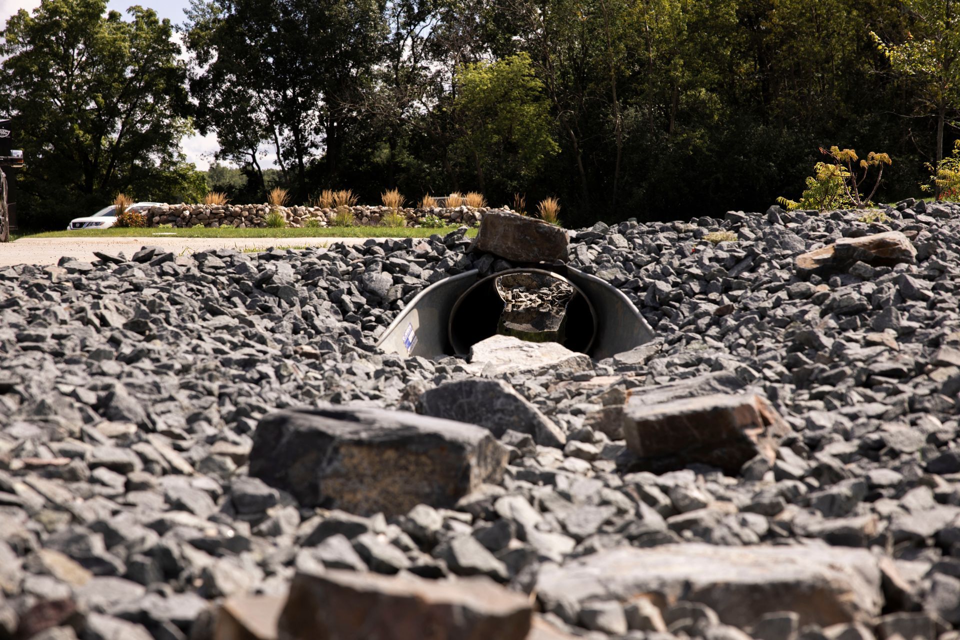 A pipe is going through a pile of rocks.