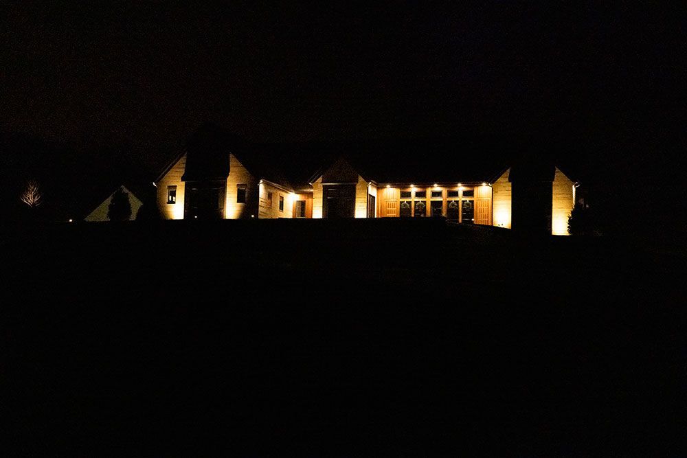 A row of houses are lit up at night.