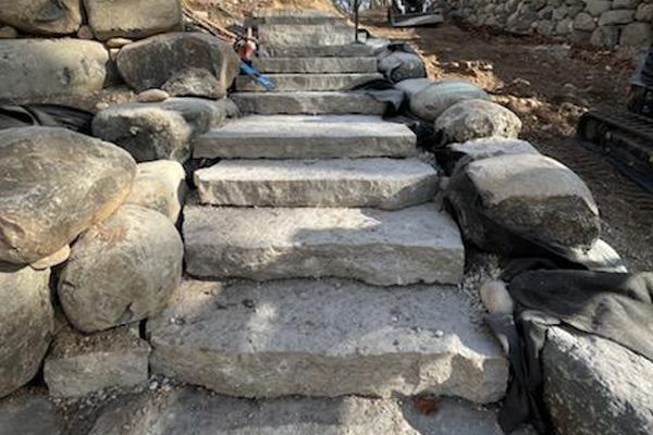 A set of stone stairs surrounded by rocks.