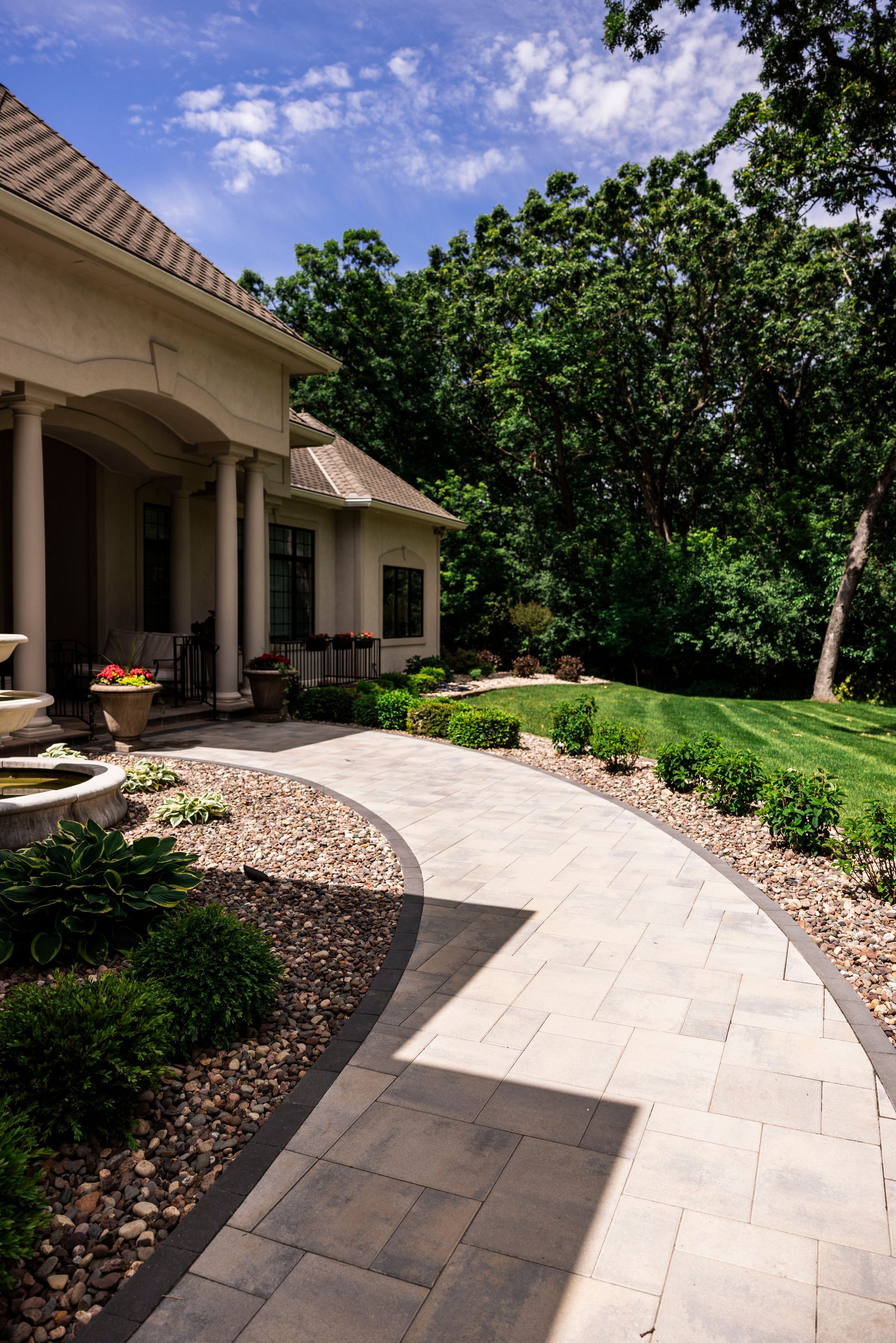 There is a walkway leading to the front of the house.