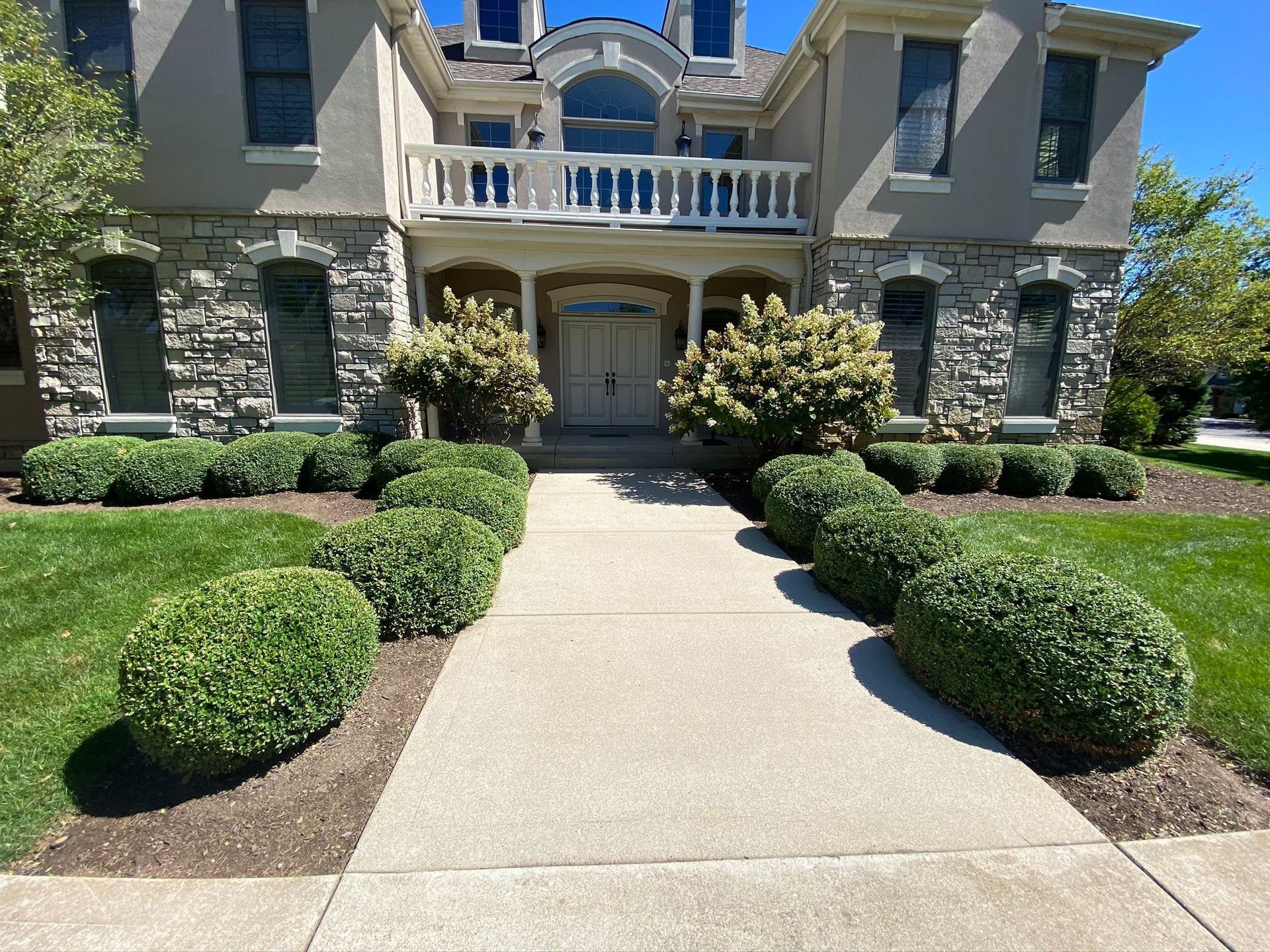 A large house with a walkway leading to it.