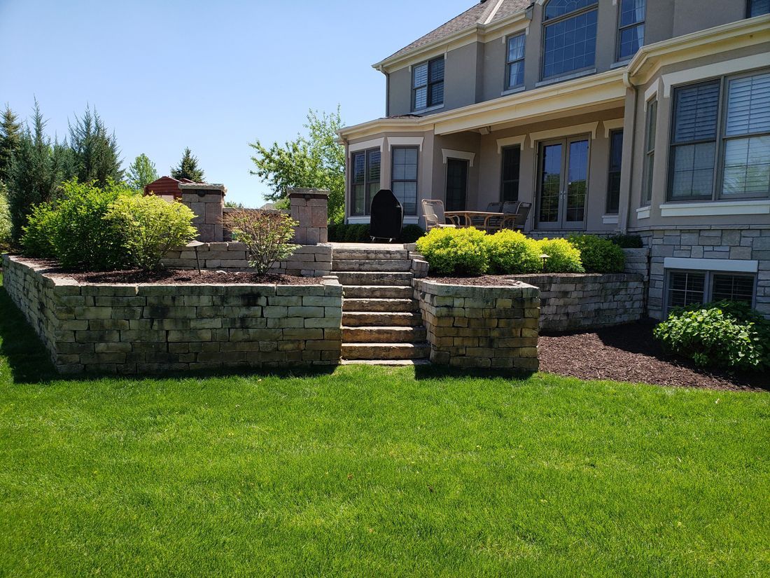 A large house with a lush green lawn in front of it.