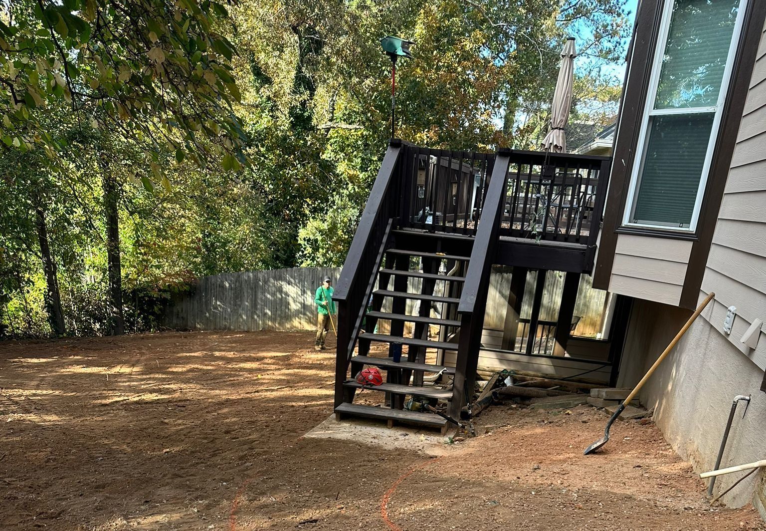 A house with a deck and stairs in the backyard.