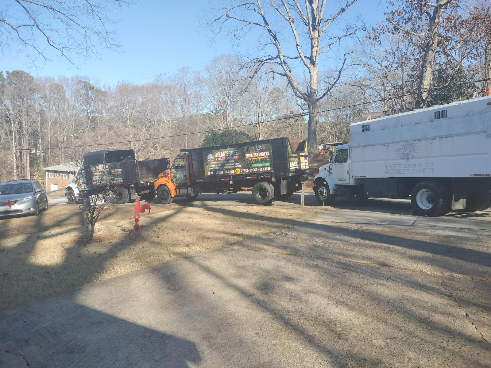A bunch of trucks are parked on the side of the road.
