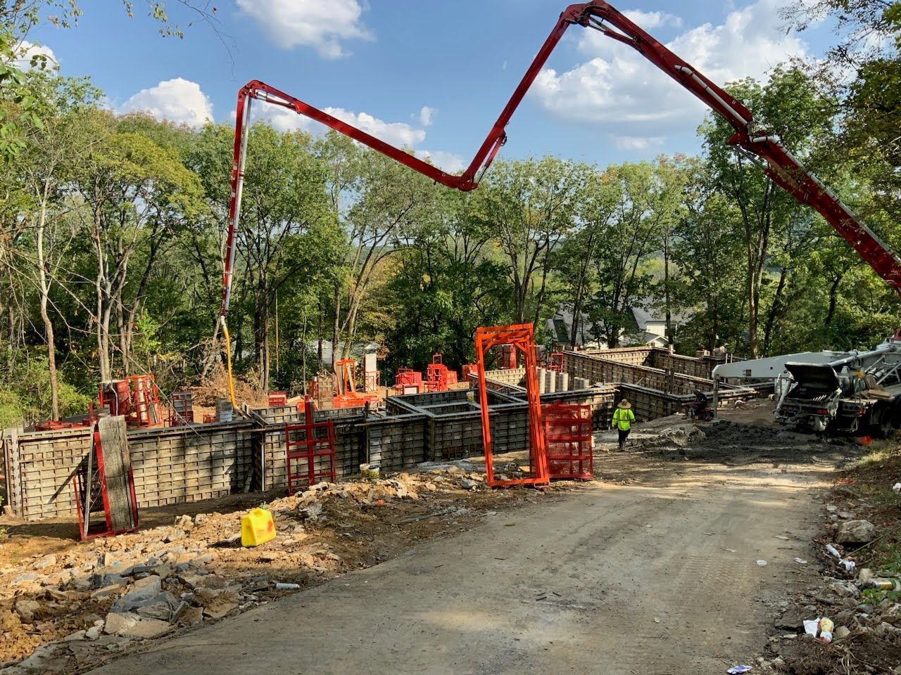 A concrete pump is being used to pour concrete on a construction site.
