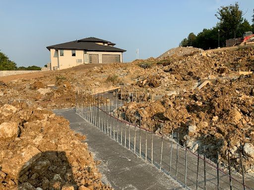 A house is being built on top of a dirt hill.