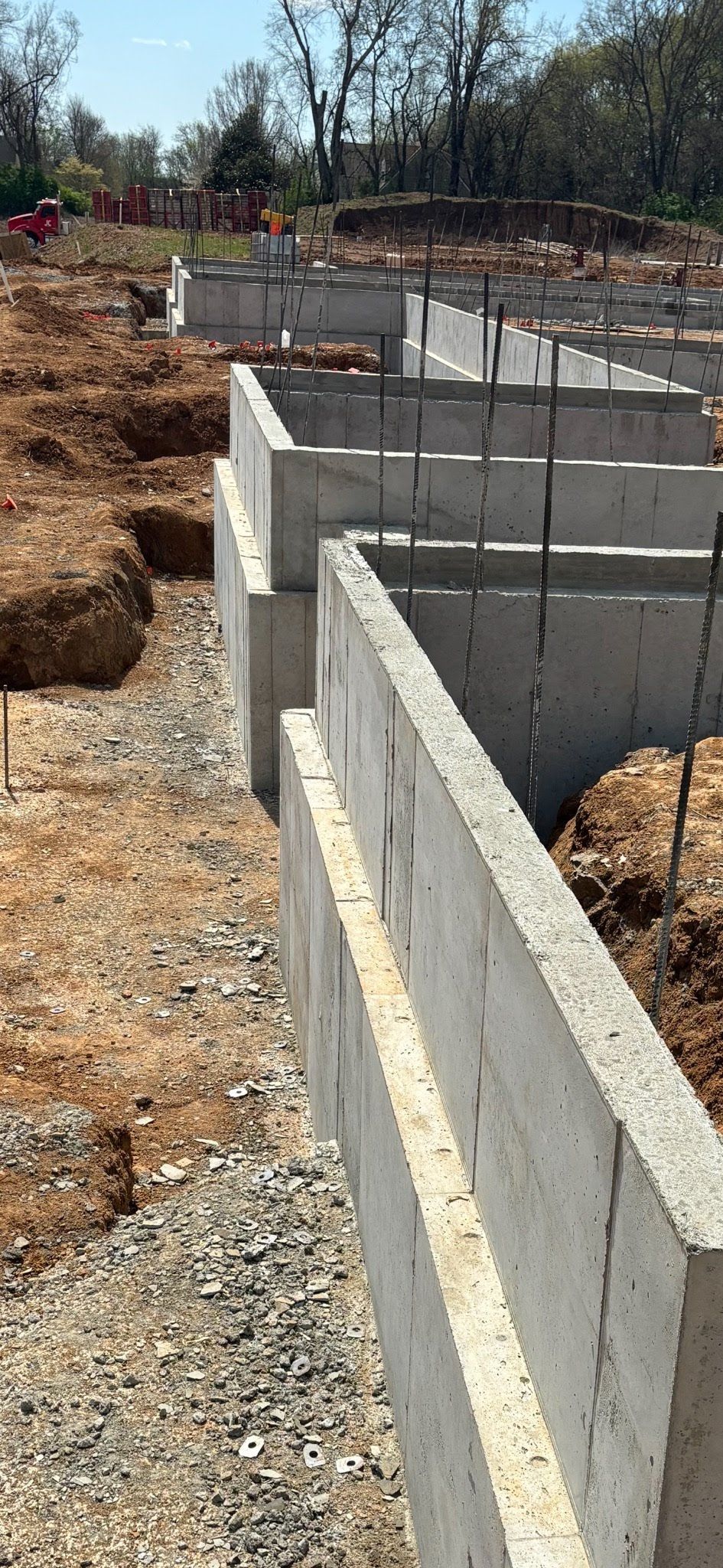 A concrete wall is being built on a construction site.