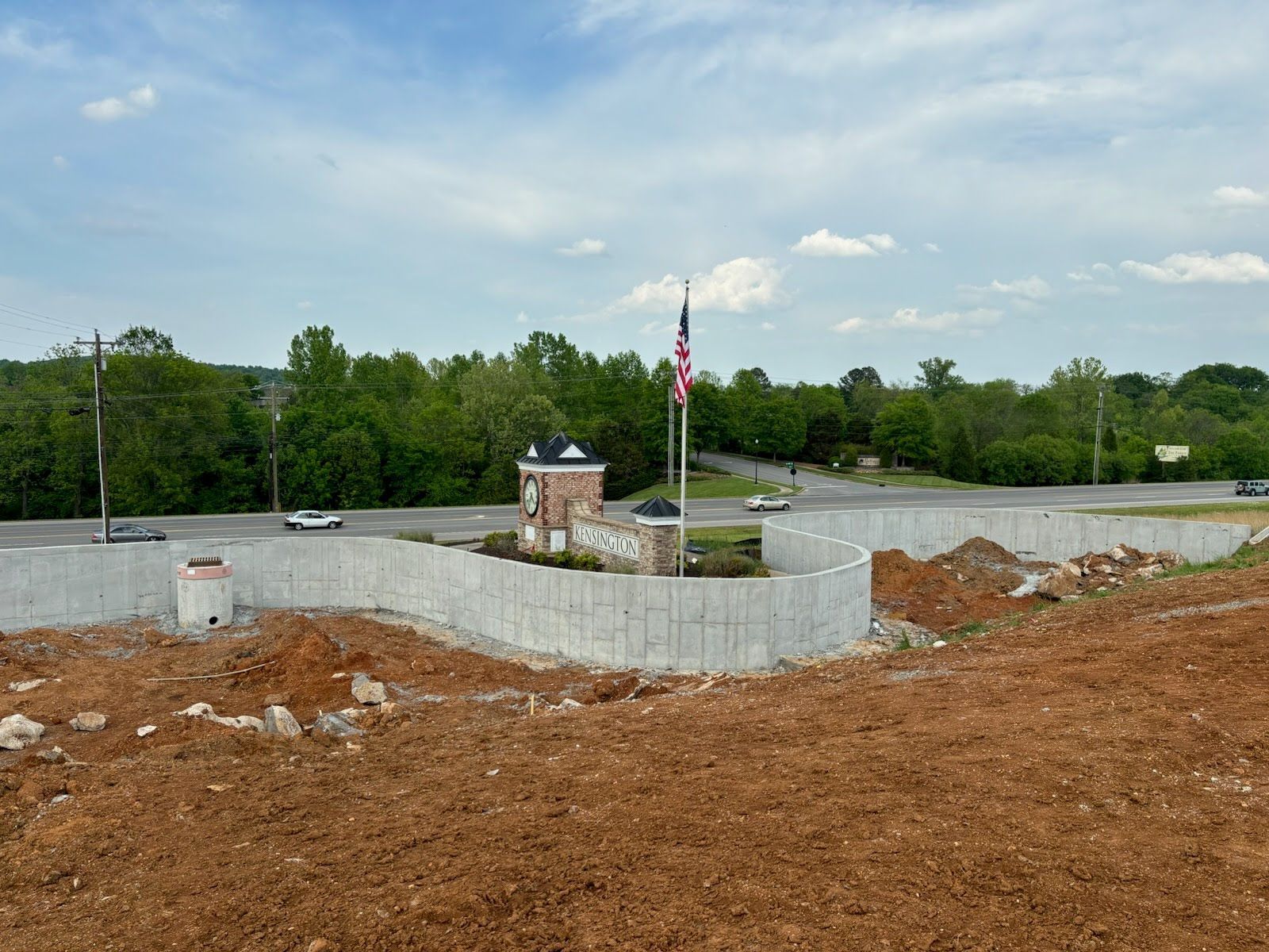 A concrete wall is being built on top of a dirt hill.