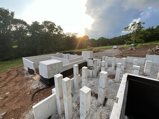 The sun is shining through the clouds over a construction site.