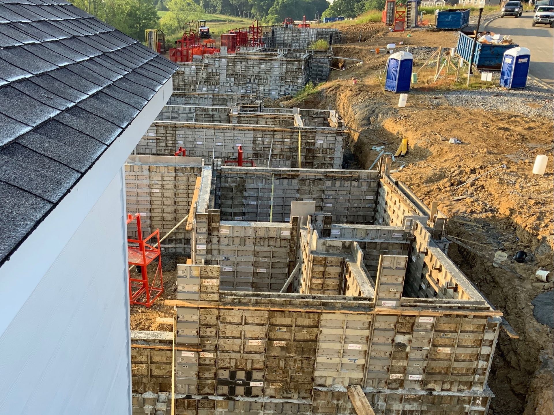 A building under construction with a roof and a lot of bricks.