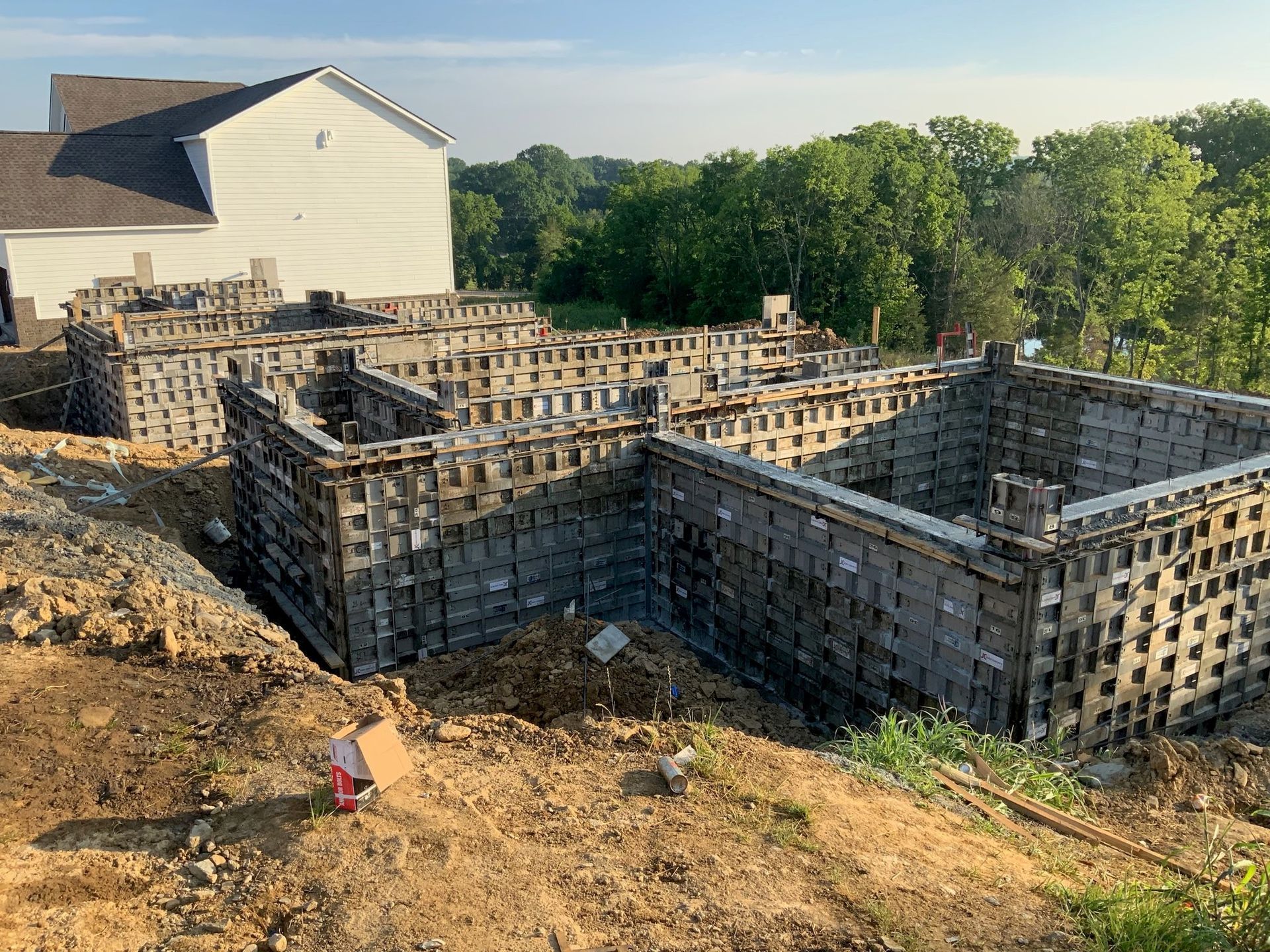 A house is being built on a hill with a lot of concrete walls.