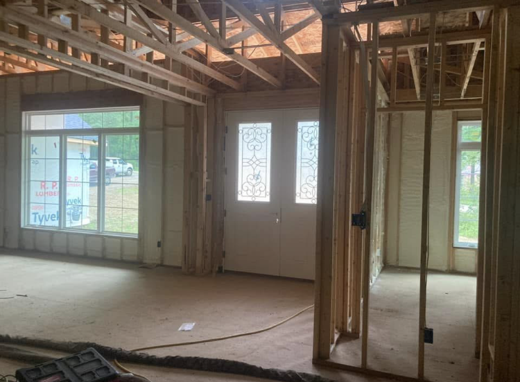 The inside of a house under construction with a lot of windows.