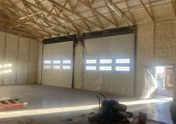 A large warehouse with a lot of doors and windows.