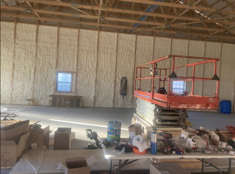 A large room with a lift in the middle of it.