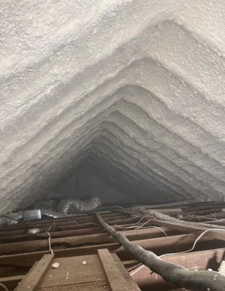 Looking up at the ceiling of an attic covered in foam.