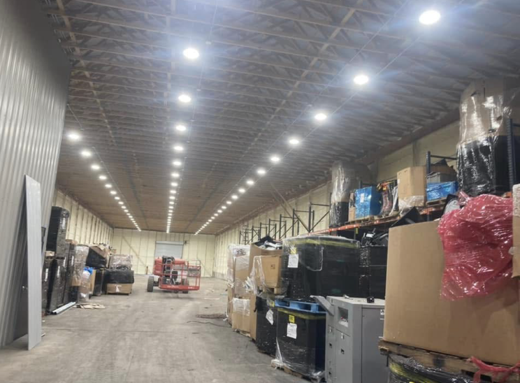 A large warehouse filled with lots of boxes and machinery.