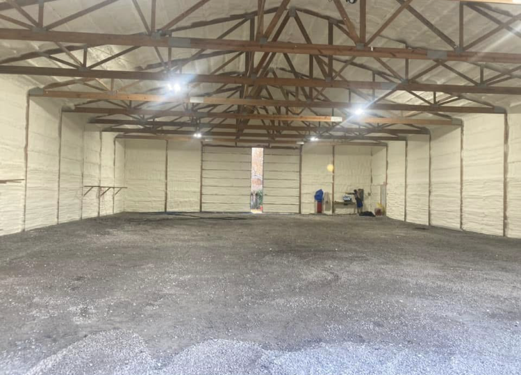 A large empty warehouse with a lot of foam on the walls and ceiling.