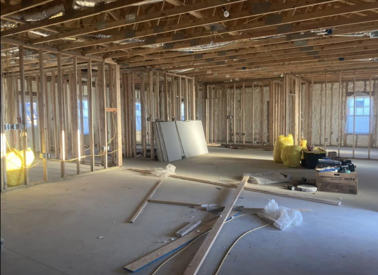The inside of a building under construction with wooden beams.