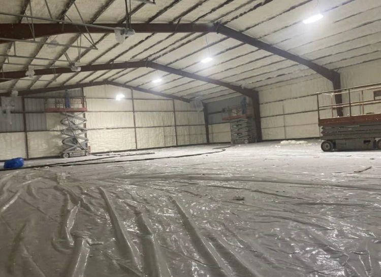 A large warehouse with a lot of plastic on the floor.